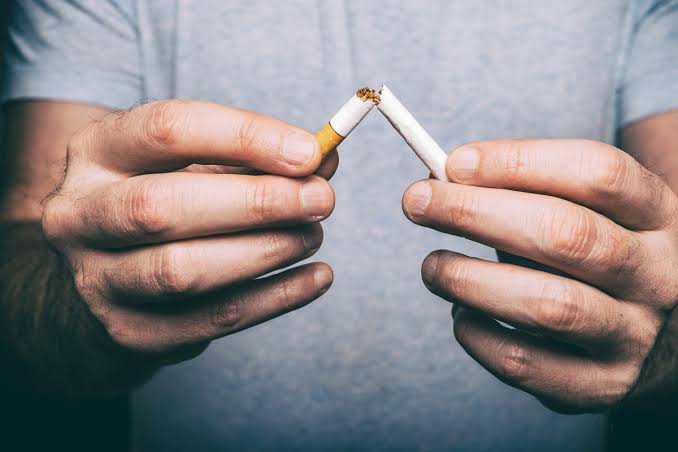 man breaks a cigarette with hands