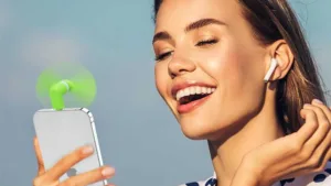 girl holding a mini fan for phone