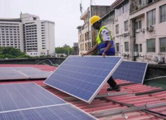 Solar Startup Ecosystem Booming in Nigeria Amid Electricity Crisis A solar startup employee installing outdoor panels Image source: Dialogue Earth
